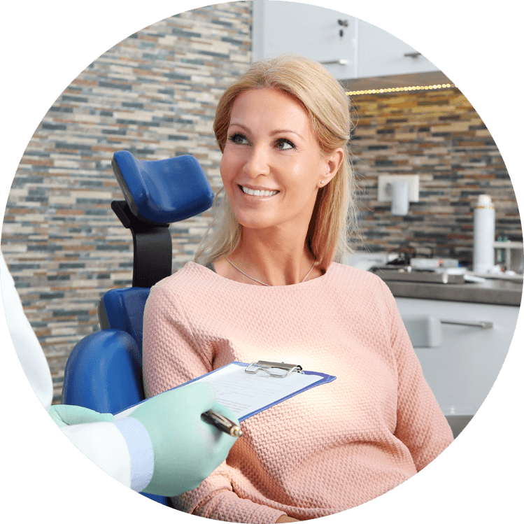 Lady smiling at the dr in dentist chair because she picked the right dentist